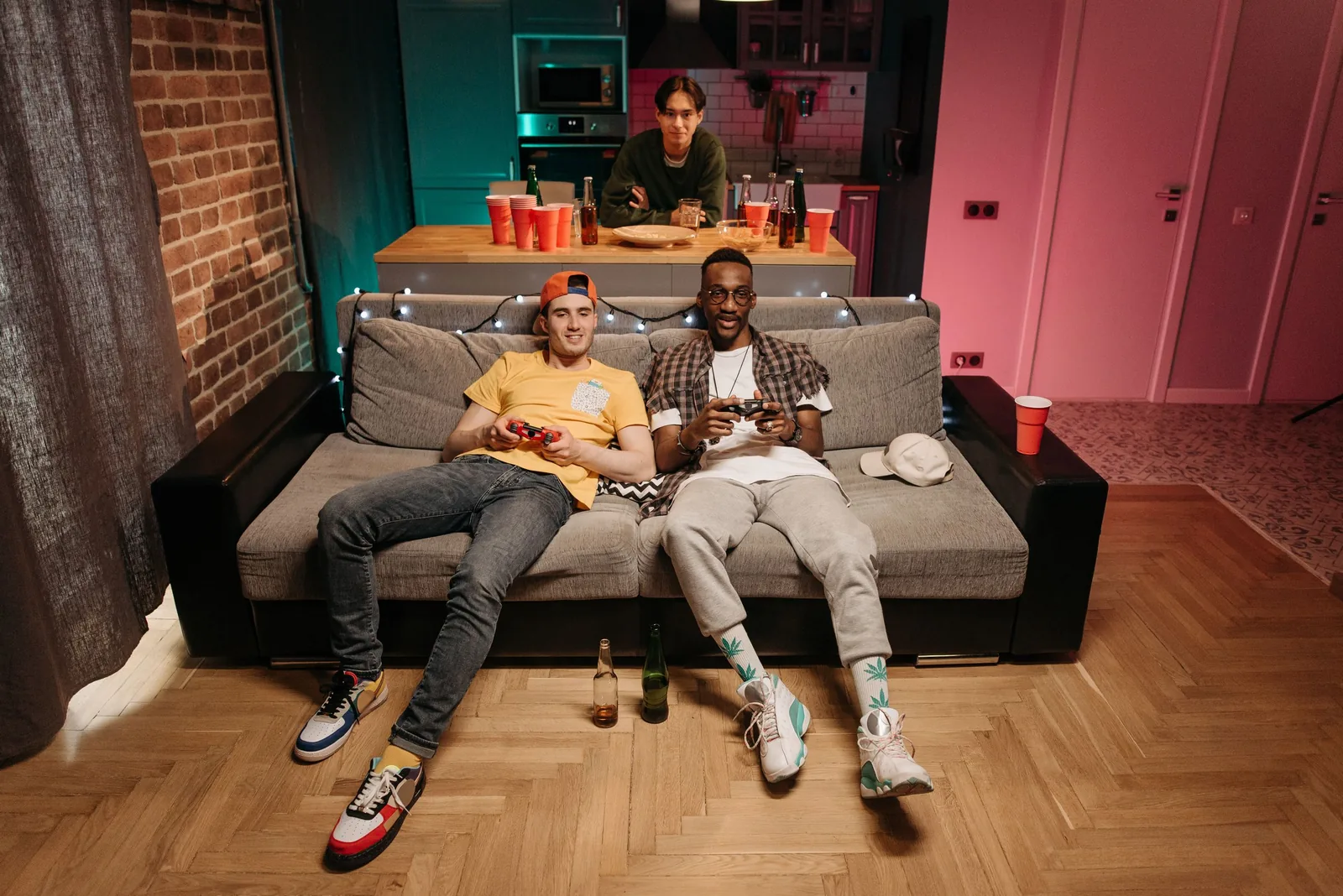 The Runout office: a sofa, two screens and a pink wall